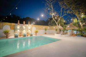 a swimming pool in a backyard at night at Villa Soledad Garden Resort in San Pablo