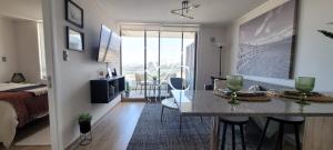 Habitación con cama y cocina con mesa en MC Suite 1 Norte en Antofagasta