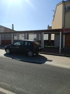 a black car parked on the side of a street at EL ABAD in Abadía