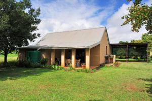 a small house in a field with a large yard at Hill Billys Selfcatering in Winterton