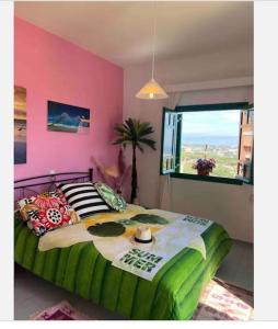een slaapkamer met een groot bed met een roze muur bij Island Away Chersonisos in Chersonissos