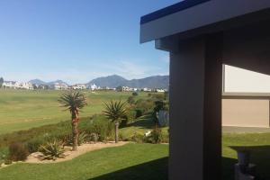 a view of a golf course from a house at Golf and Relaxation at Kingswood Golf Estate in George