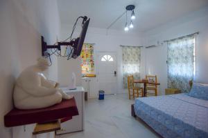 a bedroom with a statue of a woman sitting on a bench at Frenz in Soufrière
