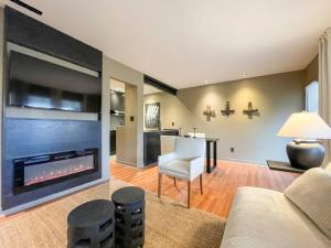a living room with a couch and a fireplace at Luxury Warehouse District Condo in Durham