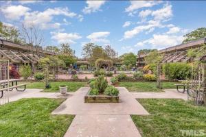 a garden with benches and tables in a building at Luxury Warehouse District Condo in Durham