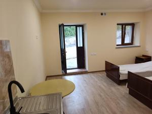a room with a bed and a desk and a table at Verishen Guest House B&B in Goris