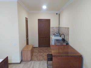 a kitchen with a sink and a wooden table at Verishen Guest House B&B in Goris