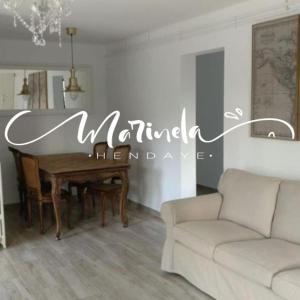 a living room with a table and a couch at Marinela in Hendaye
