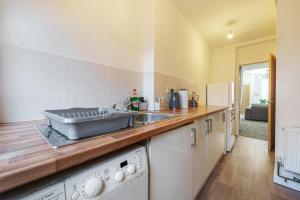 a kitchen with a sink and a counter top at Serviced Accommodation Next to Liverpool city Centre/station / stadium in Liverpool