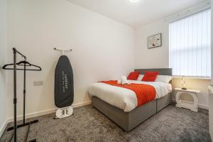 a bedroom with a large bed with red pillows at Serviced Accommodation Next to Liverpool city Centre/station / stadium in Liverpool