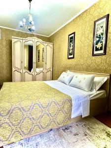 a bedroom with a large bed in a room at Двухкомнатная квартира в центре in Semey