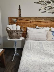 Schlafzimmer mit einem Bett und einem Korb auf einem Tisch in der Unterkunft VILLA VILLACOLLE in Procchio