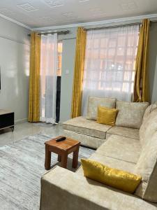 a living room with two couches and a coffee table at The comfortplace 303 Oak in Kericho