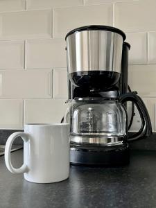 a coffee maker and a cup on a counter at CENTRAL, newly refurb 2 bed flat with FREE PARKING in Cambridge