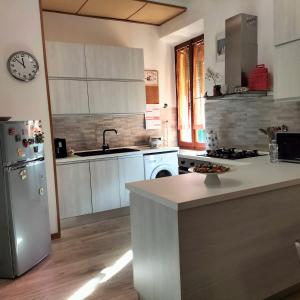 a kitchen with a refrigerator and a counter top at Casa dei MoMi in Piombino