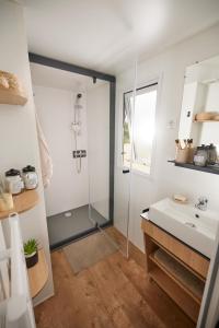 y baño con ducha y lavamanos. en Residence Marea Resort, en Santa-Lucia-di-Moriani
