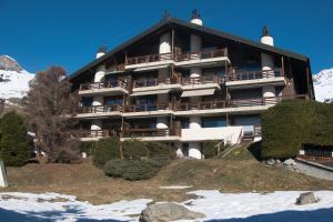 a large building on a hill with snow at Verbier Appartement Andrea in Verbier