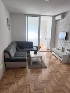 a living room with a couch and a table at Apartment 4th. Floor in Banja Luka