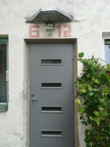 a door with a number on top of it at Metsakodu 12 in Tõrva