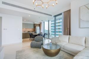 a living room with a couch and a table at Luxe Living in Beachfront / 2BR in Dubai Marina in Dubai