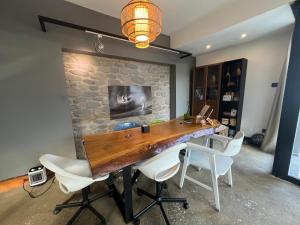 a dining room with a wooden table and white chairs at Cozy Flat in Heart of Nicosia in Lefkosa Turk