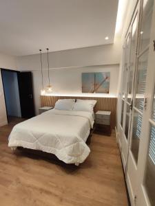 a bedroom with a large white bed in it at A uma quadra da praia de Copacabana in Rio de Janeiro