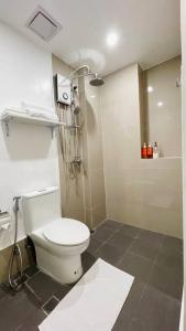 a bathroom with a white toilet and a shower at WV2 Condotel Luxury in Iloilo City