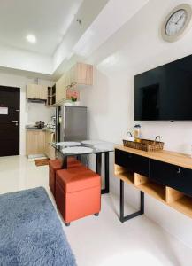 a kitchen with a table and a tv in a room at WV2 Condotel Luxury in Iloilo City