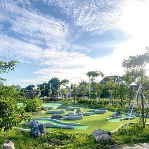 a park with many green inflatables on the grass at WV2 Condotel Luxury in Iloilo City