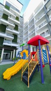 a playground with a slide in front of a building at WV2 Condotel Luxury in Iloilo City