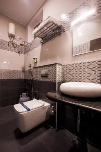 a bathroom with a toilet and a sink at SMA Grand inn, Triplicane in Chennai