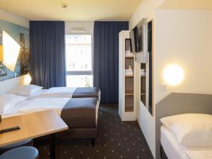 Postel nebo postele na pokoji v ubytování B&B Hotel Kiel-Wissenschaftspark