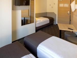 Postel nebo postele na pokoji v ubytování B&B Hotel Kiel-Wissenschaftspark