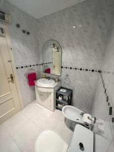 bagno con lavandino, servizi igienici e specchio di Chalet La Mata a Torrevieja