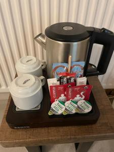 a table with a coffee pot and a tray of food at Denham Mount in Buckinghamshire