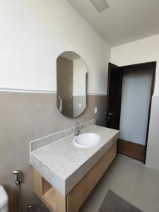 a bathroom with a sink and a mirror at A uma quadra da praia de Copacabana in Rio de Janeiro