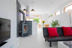 a living room with a couch and a fireplace at King Bed Joy Lane, Chichester near Goodwood in Chichester