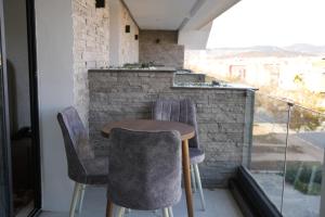 a small table and chairs on a balcony at Le Rocher De L'Atlas in Azrou
