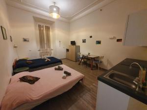 a kitchen with a bed and a sink in a room at La Casa a Trastevere in Rome