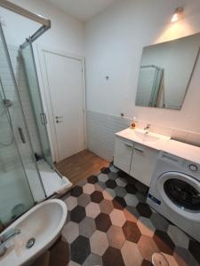 a bathroom with a sink and a washing machine at La Casa a Trastevere in Rome