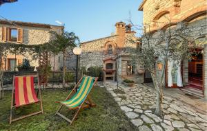 two lawn chairs in the yard of a house at 2 Bedroom Beautiful Home In Corciano in Corciano