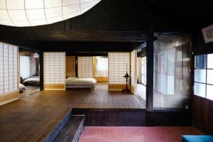 een kamer met een bed en een kamer met ramen bij Ryunohara Hatago in Tanabe