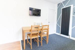 a dining room with a wooden table and chairs at Charming Studio Haven in Birmingham