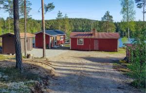 a couple of small buildings in a forest at Gorgeous Home In Mariannelund With House Sea View in Mariannelund