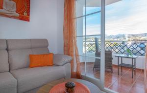 a living room with a couch and a balcony at Beautiful Apartment In Torrox in Torrox