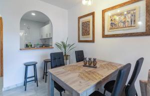 a dining room with a wooden table and chairs at Beautiful Apartment In Torrox in Torrox