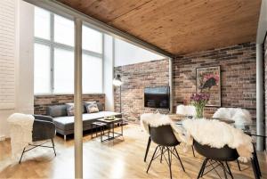 a living room with a brick wall at Riverside Loft With Sauna in Turku