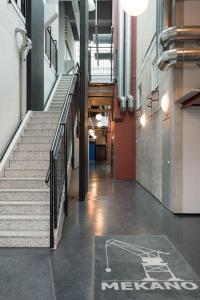 a hallway of a building with stairs and a sign on the floor at Riverside Loft With Sauna in Turku