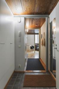 a hallway with a door leading to a living room at Riverside Loft With Sauna in Turku