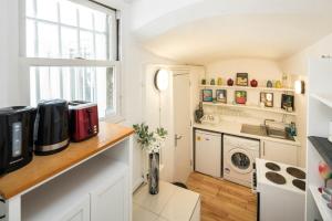 a kitchen with a washer and dryer on a counter at Marvellous Flat in Earls Court in London
